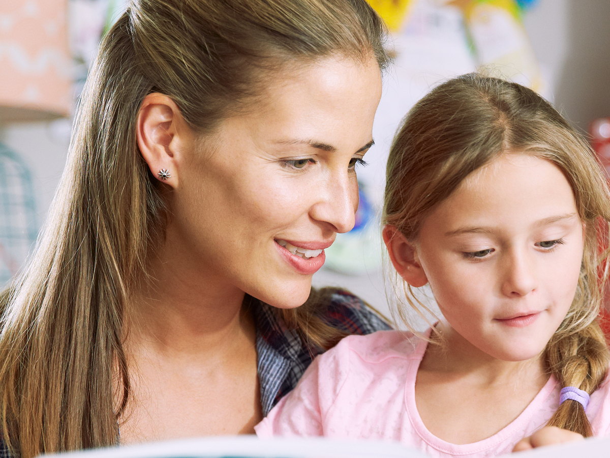 A mother and daughter reading together at home