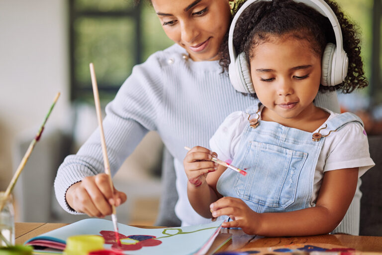 Parent and child working together on developmental activities at home