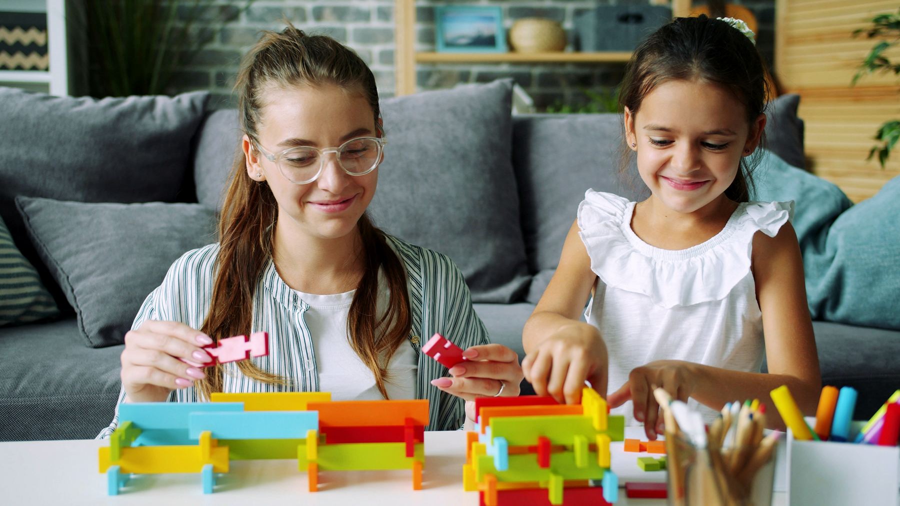 Parent and child working together on a learning activity at home