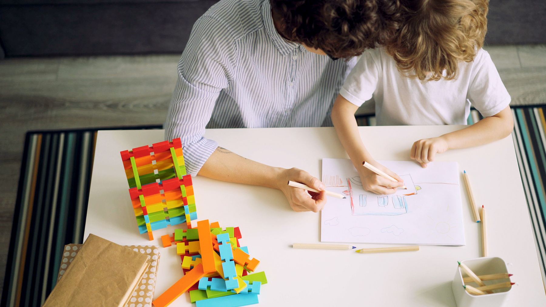Parent and child working together on a learning activity at home