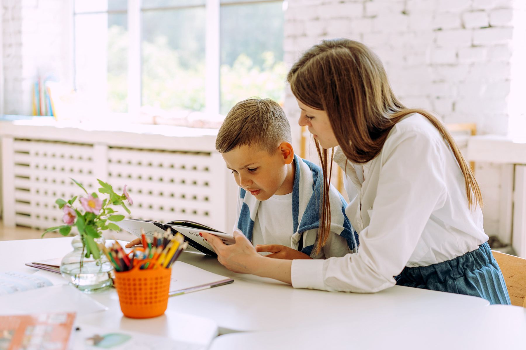 Parent and child working together on a learning activity at home