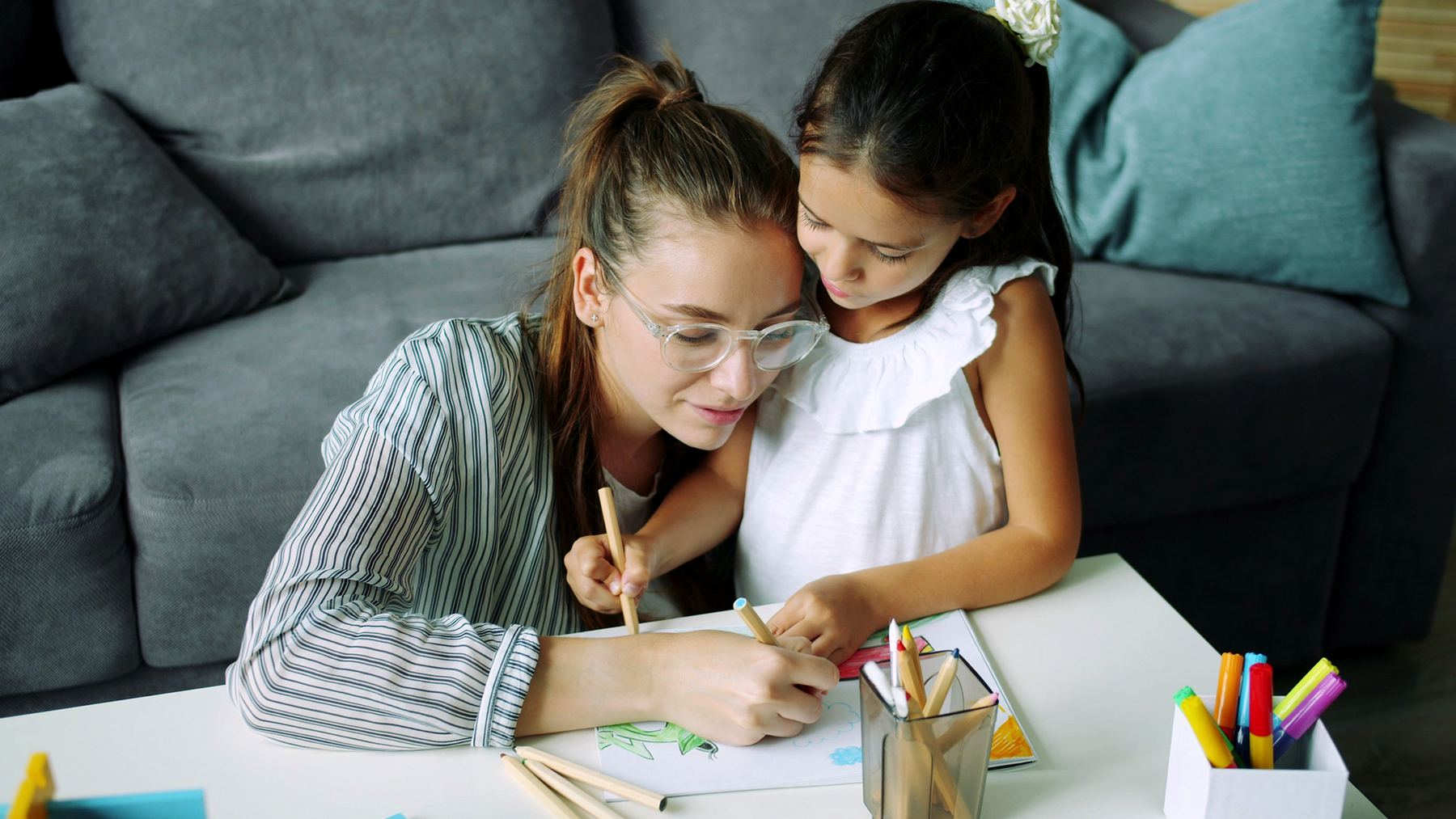 Parent and child working together on a learning activity at home