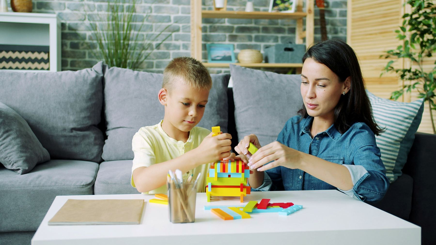 Parent and child working together on a learning activity at home