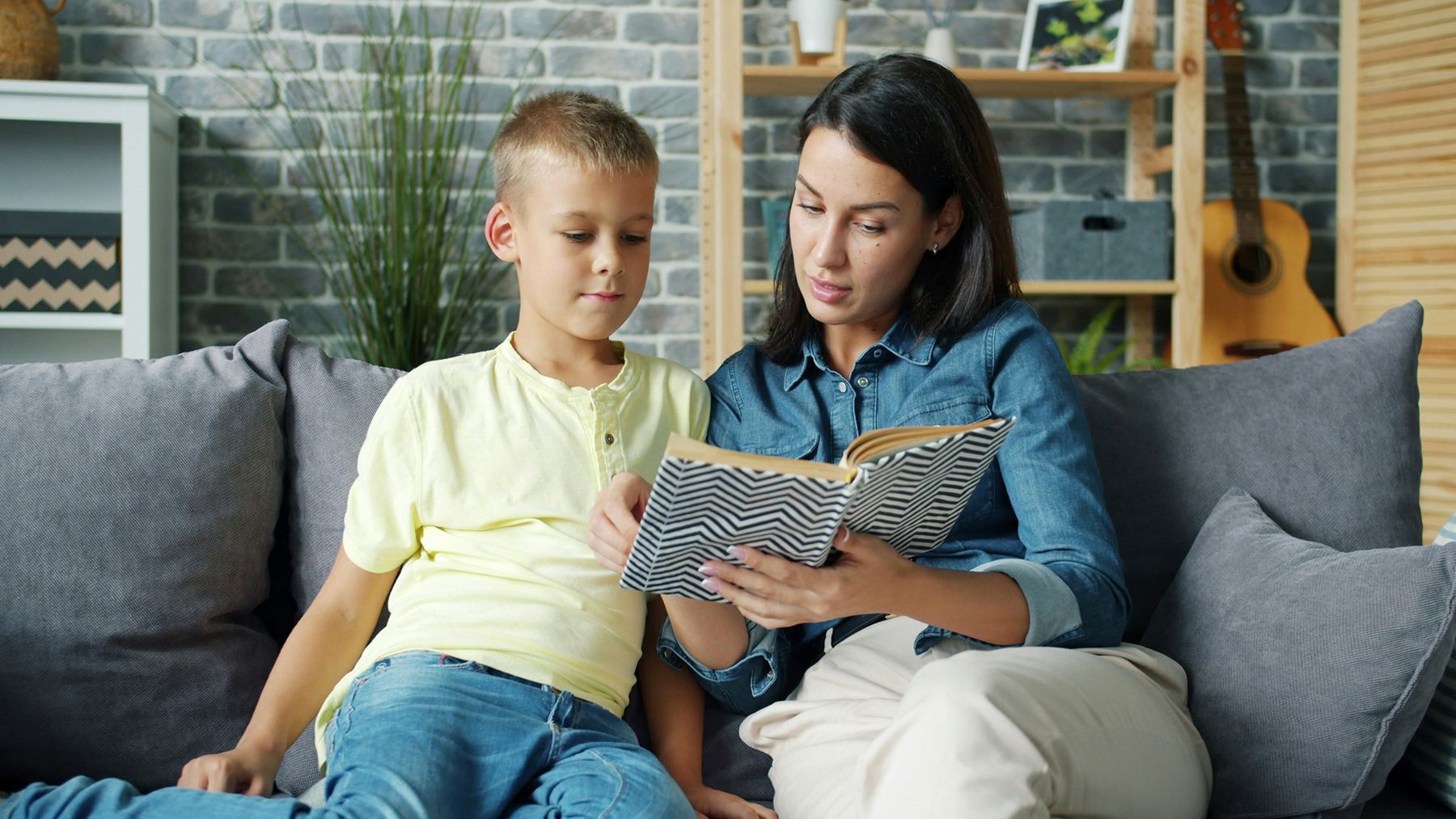 Parent and child working together on a learning activity at home