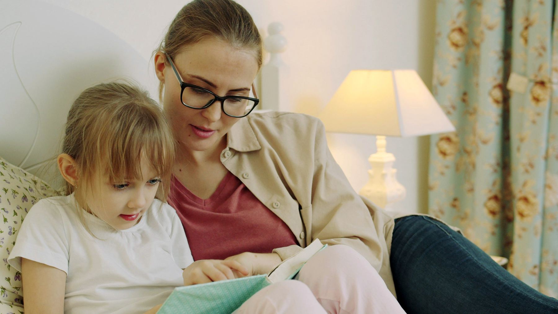 Parent and child working together on a learning activity at home