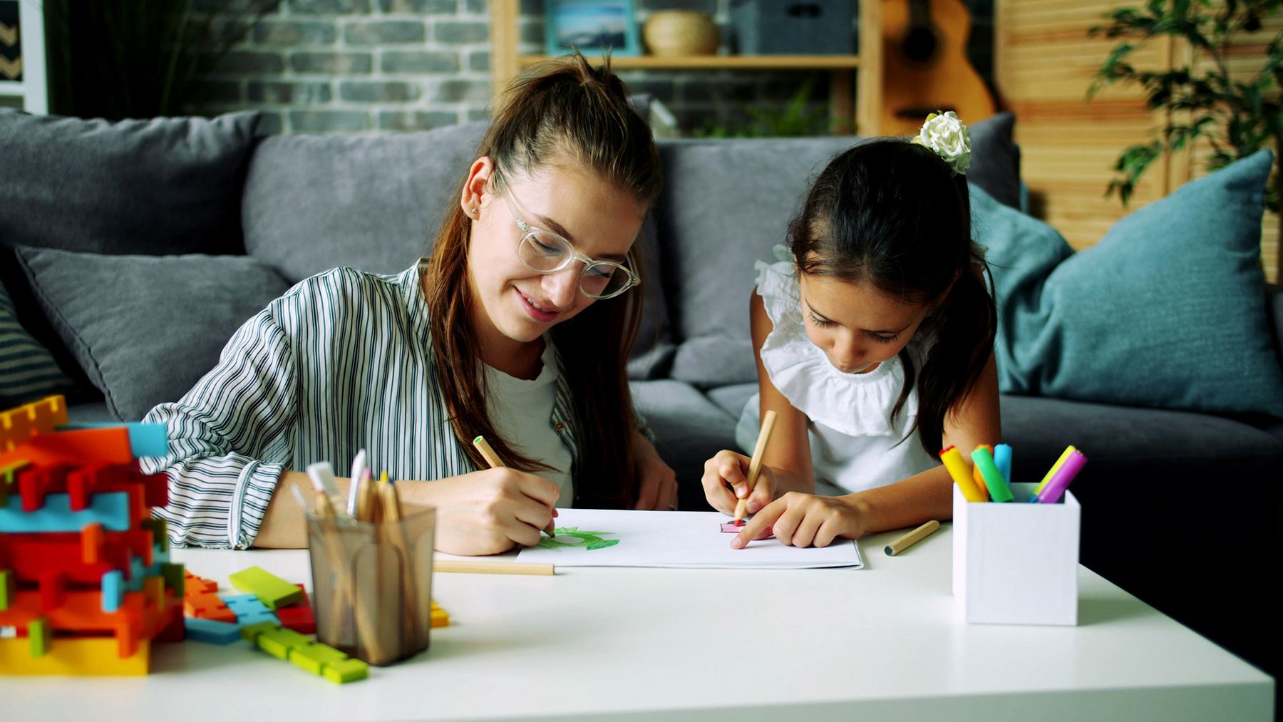 Parent and child working together on a learning activity at home